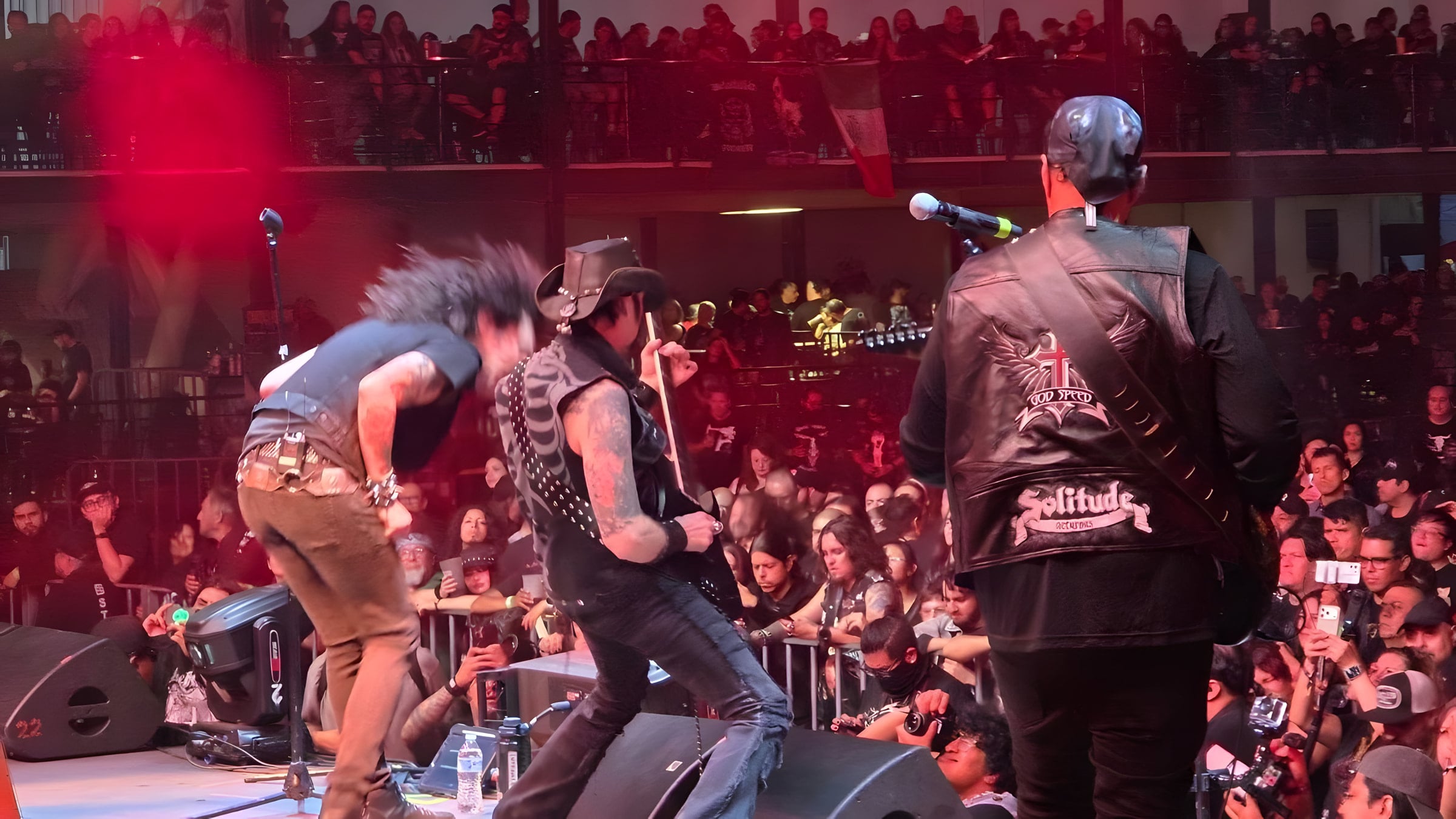 Seen from behind the band on stage: James-Paul Luna, Lyle Blackburn and Edgar Rivera face a crowd that fills the floor and the balconies above.